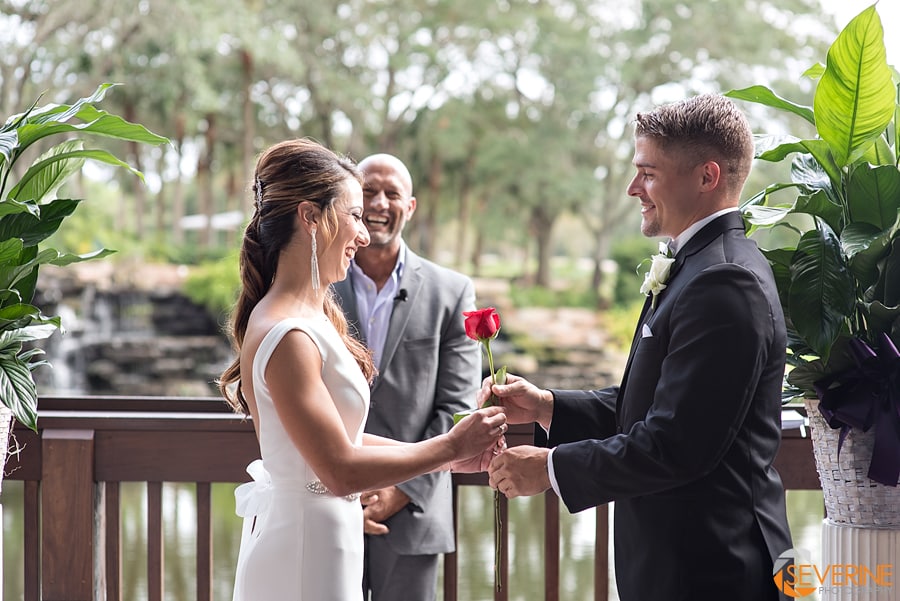 bride offering a rose to the groom